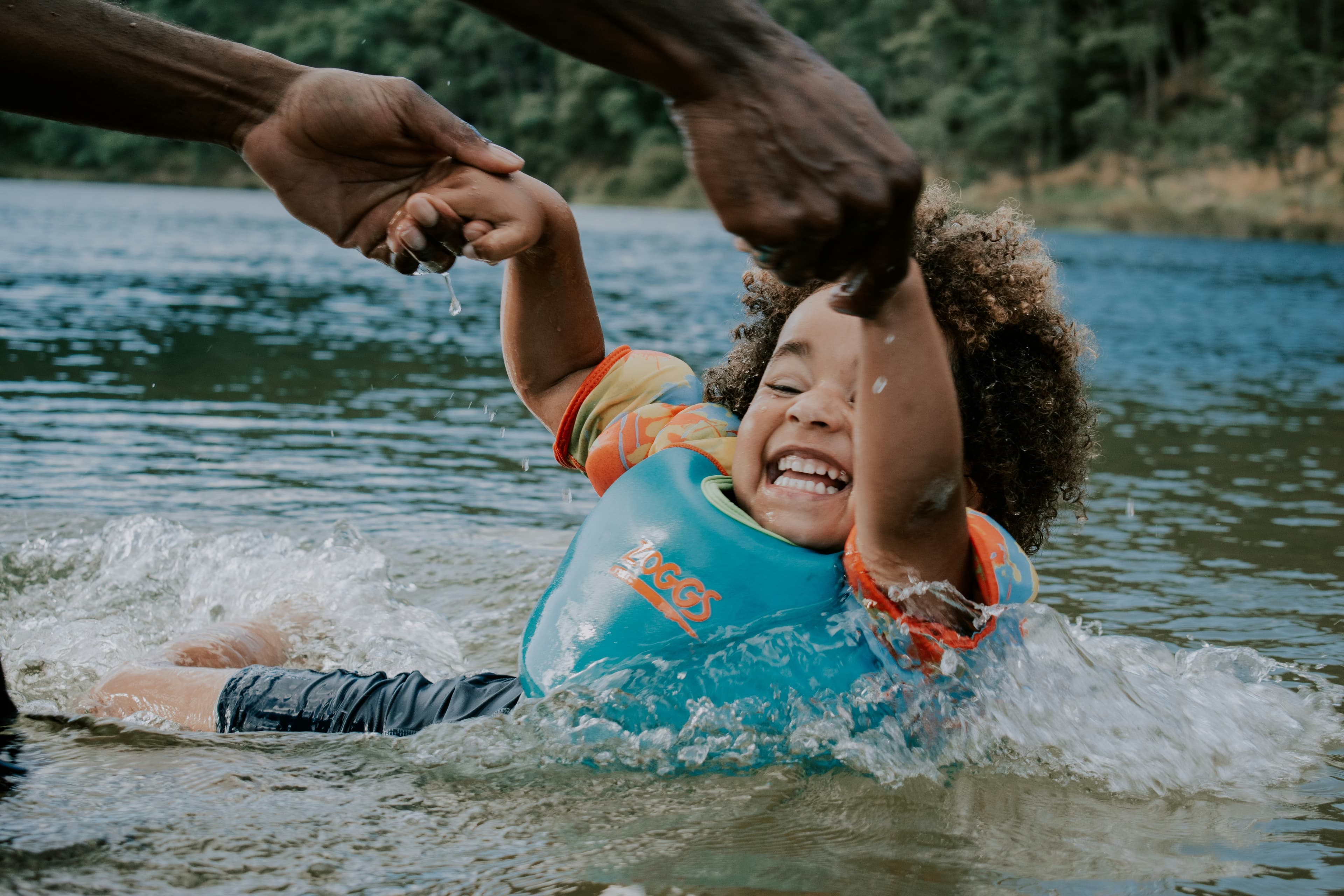 Parent and toddler enjoying water play together